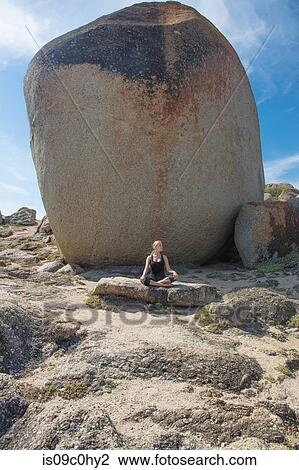 Young woman practicing lotus yoga pose on beach rock, Cape Town, Western Cape, South Africa View Large Photo Image Stock Image - Young woman practicing lotus yoga pose on beach rock, Cape Town, Western Cape, South Africa. Fotosearch