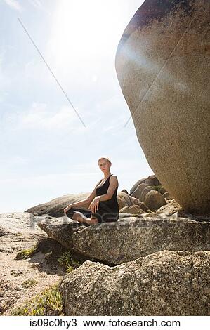 Young woman practicing lotus yoga pose on beach rock, portrait, Cape Town, Western Cape, South Africa View Large Photo Image Stock Image - Young woman practicing lotus yoga pose on beach rock, portrait, Cape Town, Western Cape, South Africa. Fotosearch