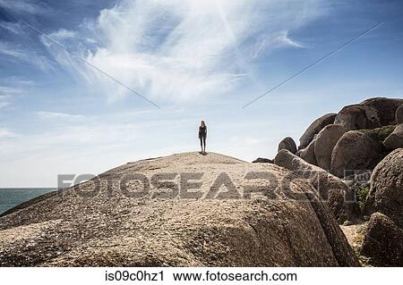 Young woman practicing yoga taking a break standing on top of beach boulder, Cape Town, Western Cape, South Africa View Large Photo Image Stock Image - Young woman practicing yoga taking a break standing on top of beach boulder, Cape Town, Western Cape, South Africa. Fotosearch
