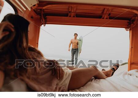 Young woman reclining in back of recreational vehicle waiting for surfer boyfriend on beach, Jalama, Ventura, California, USA View Large Photo Image Stock Image - Young woman reclining in back of recreational vehicle waiting for surfer boyfriend on beach, Jalama, Ventura, California, USA. Fotosearch