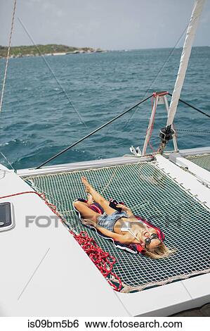 Young woman relaxing on sailing boat, British Virgin Islands View Large Photo Image Stock Photograph - Young woman relaxing on sailing boat, British Virgin Islands. Fotosearch