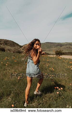 Young woman running in field of wildflowers, portrait, Jalama, California, USA View Large Photo Image Stock Photograph - Young woman running in field of wildflowers, portrait, Jalama, California, USA. Fotosearch