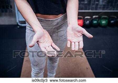 Young woman showing calluses on palms in gym View Large Photo Image Stock Image - Young woman showing calluses on palms in gym. Fotosearch