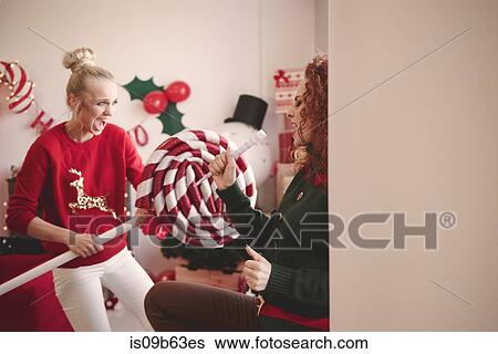 Young woman singing with pretend microphone at christmas party View Large Photo Image Stock Photograph - Young woman singing with pretend microphone at christmas party. Fotosearch