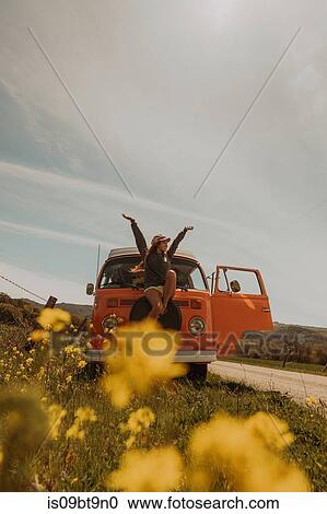 Young woman sitting on front of recreational vehicle by rural road, Jalama, California, USA View Large Photo Image Stock Image - Young woman sitting on front of recreational vehicle by rural road, Jalama, California, USA. Fotosearch