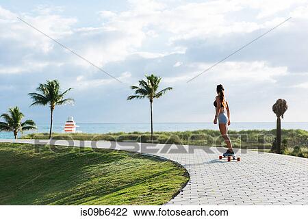 Young woman skateboarding in park, rear view, South Point Park, Miami Beach, Florida, USA View Large Photo Image Stock Image - Young woman skateboarding in park, rear view, South Point Park, Miami Beach, Florida, USA. Fotosearch