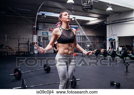 Young woman skipping in gym View Large Photo Image Picture - Young woman skipping in gym. Fotosearch