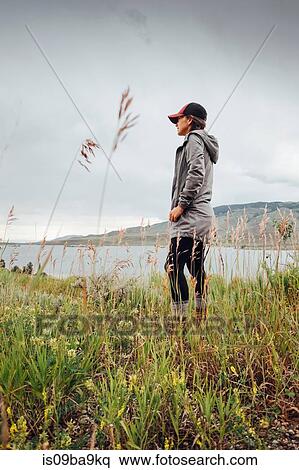 Young woman standing near Dillon Reservoir, looking at view,, Silverthorne, Colorado, USA View Large Photo Image Stock Photography - Young woman standing near Dillon Reservoir, looking at view,, Silverthorne, Colorado, USA. Fotosearch