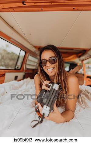 Young woman sticking out tongue from back of recreational vehicle at beach, portrait, Jalama, California, USA View Large Photo Image Stock Image - Young woman sticking out tongue from back of recreational vehicle at beach, portrait, Jalama, California, USA. Fotosearch