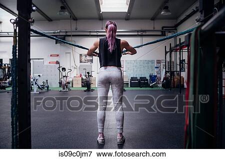 Young woman stretching arms in gym View Large Photo Image Stock Photo - Young woman stretching arms in gym. Fotosearch
