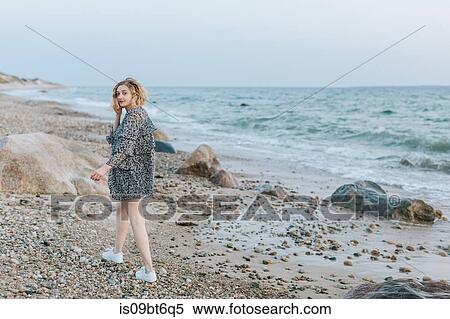 Young woman strolling on beach, portrait, Menemsha, Martha's Vineyard, Massachusetts, USA View Large Photo Image Stock Photography - Young woman strolling on beach, portrait, Menemsha, Martha's Vineyard, Massachusetts, USA. Fotosearch