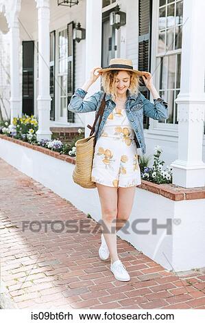 Young woman strolling on sidewalk wearing straw boater, Menemsha, Martha's Vineyard, Massachusetts, USA View Large Photo Image Stock Image - Young woman strolling on sidewalk wearing straw boater, Menemsha, Martha's Vineyard, Massachusetts, USA. Fotosearch