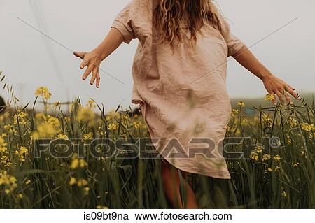 Young woman walking in yellow wildflower field, rear view, Jalama, California, USA View Large Photo Image Stock Image - Young woman walking in yellow wildflower field, rear view, Jalama, California, USA. Fotosearch