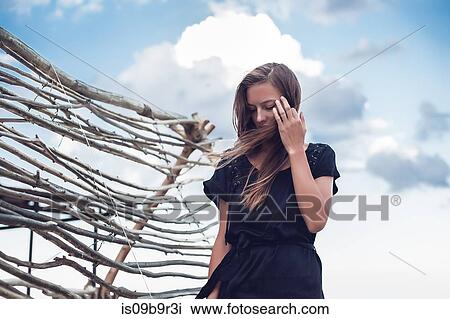 Young woman with hand in flyaway hair on beach, Odessa, Odessa Oblast, Ukraine View Large Photo Image Stock Image - Young woman with hand in flyaway hair on beach, Odessa, Odessa Oblast, Ukraine. Fotosearch
