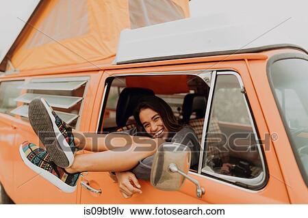 Young woman with legs through recreational vehicle window at beach, portrait, Jalama, California, USA View Large Photo Image Stock Photo - Young woman with legs through recreational vehicle window at beach, portrait, Jalama, California, USA. Fotosearch