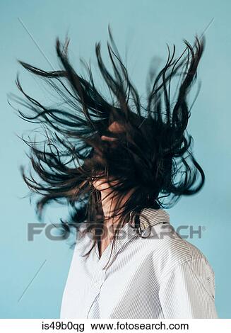 Young woman with long hair, tossing head back View Large Photo Image Stock Image - Young woman with long hair, tossing head back. Fotosearch