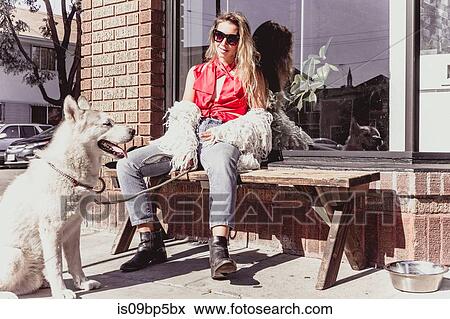 Young woman with pet dog at shopfront View Large Photo Image Stock Photo - Young woman with pet dog at shopfront. Fotosearch