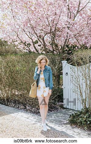 Young woman with straw bag in front of pink tree blossom, Menemsha, Martha's Vineyard, Massachusetts, USA View Large Photo Image Stock Image - Young woman with straw bag in front of pink tree blossom, Menemsha, Martha's Vineyard, Massachusetts, USA. Fotosearch