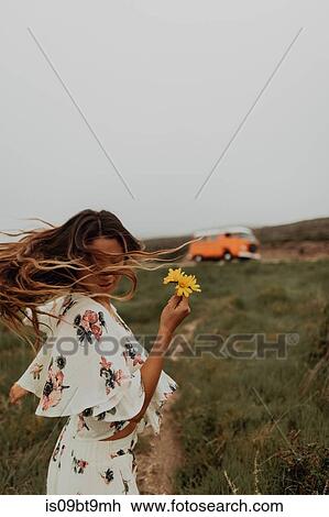 Young woman with wildflowers dancing at coast, Jalama, California, USA View Large Photo Image Stock Image - Young woman with wildflowers dancing at coast, Jalama, California, USA. Fotosearch