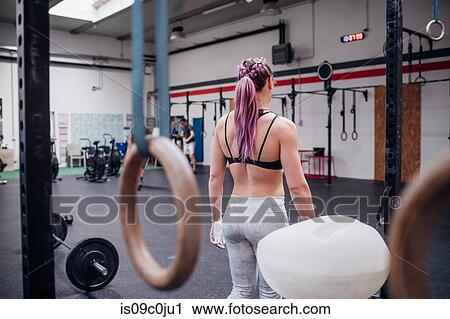 Young woman working out in gym View Large Photo Image Stock Image - Young woman working out in gym. Fotosearch
