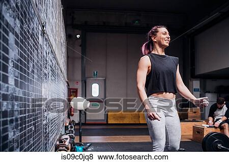 Young woman working out in gym View Large Photo Image Stock Photo - Young woman working out in gym. Fotosearch
