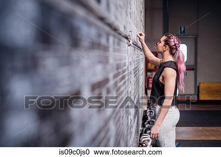Young woman writing on scoreboard in gym View Large Photo Image Stock Image - Young woman writing on scoreboard in gym. Fotosearch