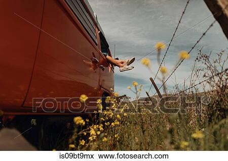 Young woman's legs out of recreational vehicle window on rural roadside, Jalama, California, USA View Large Photo Image Stock Photo - Young woman's legs out of recreational vehicle window on rural roadside, Jalama, California, USA. Fotosearch