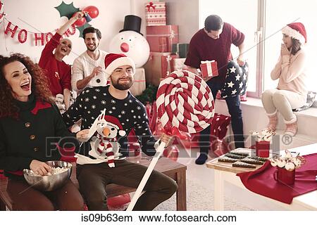 Young women and men having fun at christmas party View Large Photo Image Picture - Young women and men having fun at christmas party. Fotosearch