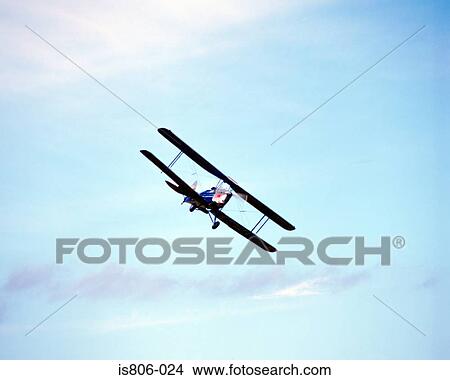 A biplane in flight View Large Photo Image Picture - A biplane in flight. Fotosearch