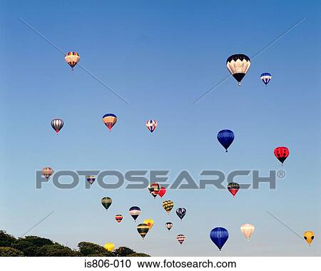 Stock Image - Colourful balloons in clear blue sky . Fotosearch