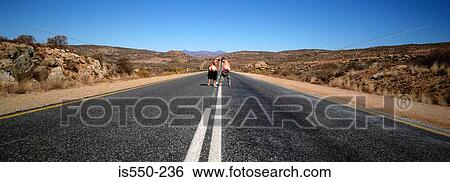 Stock Photograph - People mooning on desert road. Fotosearch
