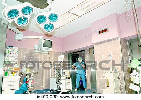 Stock Image - Surgical staff member in theatre. Fotosearch