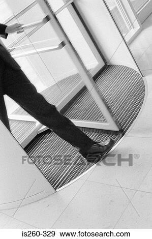 Man using revolving door View Large Photo Image Stock Photo - Man using revolving door. Fotosearch
