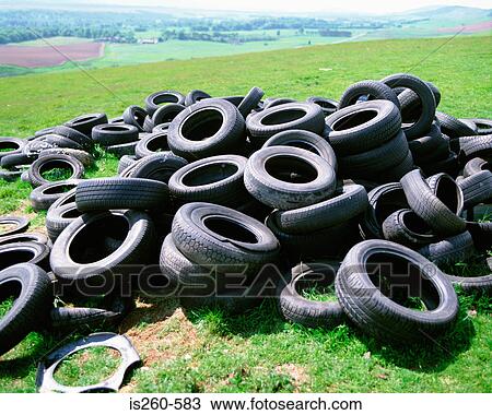Tyres dumped in countryside View Large Photo Image Stock Image - Tyres dumped in countryside. Fotosearch
