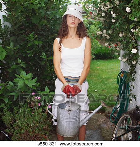 Woman tending the garden View Large Photo Image Stock Image - Woman tending the garden. Fotosearch