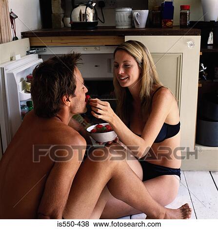 Stock Photo - Young woman feeding partner. Fotosearch
