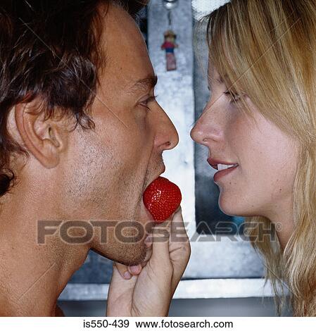 Young woman feeding partner View Large Photo Image Stock Photo - Young woman feeding partner. Fotosearch