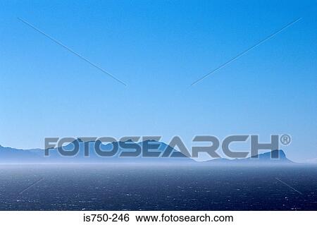 Stock Photograph - Blue mountainous coast. Fotosearch