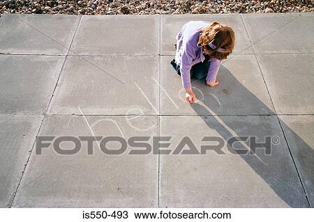 Stock Image - Girl sitting on ground writing. Fotosearch