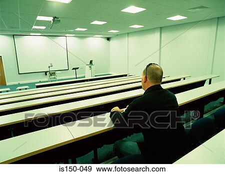 Man sits in empty auditorium View Large Photo Image Stock Photo - Man sits in empty auditorium. Fotosearch