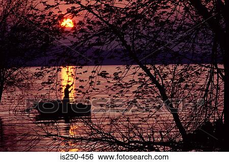 Stock Photograph - Silhouetted person on lake. Fotosearch
