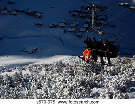 Skiers waving from ski-lift View Large Photo Image Stock Photography - Skiers waving from ski-lift. Fotosearch