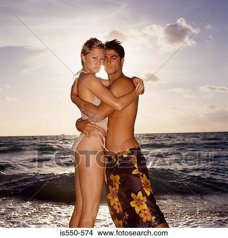 Picture - Couple hugging on beach. Fotosearch
