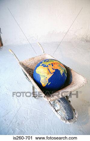 Stock Image - Earth in a wheelbarrow. Fotosearch
