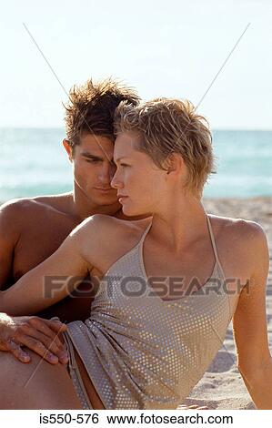 Young couple relaxing on beach View Large Photo Image Stock Photograph - Young couple relaxing on beach. Fotosearch