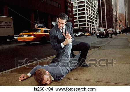 Businessmen fighting in street View Large Photo Image Picture - Businessmen fighting in street. Fotosearch