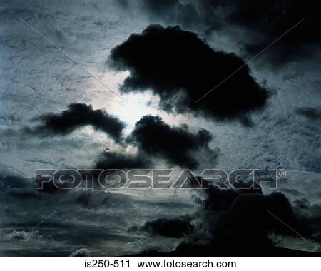 Silhouetted clouds in sky View Large Photo Image Stock Image - Silhouetted clouds in sky. Fotosearch