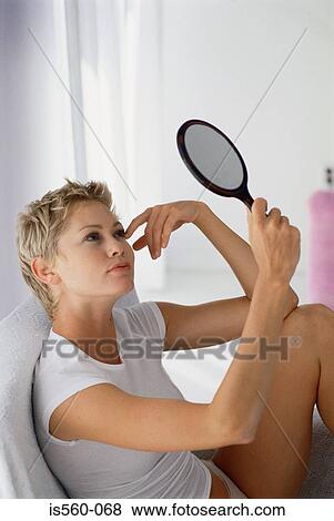 Woman using a hand mirror View Large Photo Image Stock Photo - Woman using a hand mirror. Fotosearch