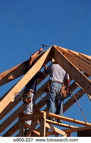 Builders working on roof View Large Photo Image Stock Photo - Builders working on roof. Fotosearch