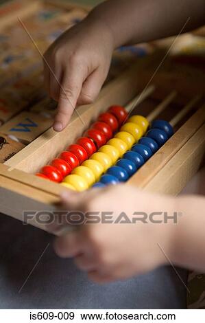 Child using an abacus View Large Photo Image Stock Photo - Child using an abacus. Fotosearch